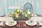 The table was anchored by an arrangement of pale blooms and succulents. The table was anchored by an arrangement of pale blooms and succulents.