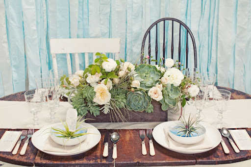 The table was anchored by an arrangement of pale blooms and succulents. The table was anchored by an arrangement of pale blooms and succulents.