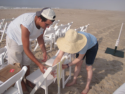 Anthony and I start hanging them on each chair.