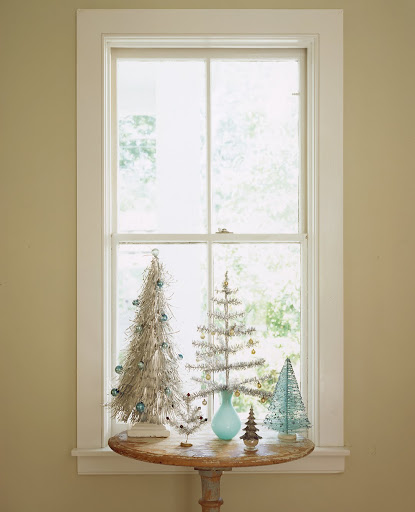 Here is a grove of 1960s tabletop trees, including (from left) an aluminum tree that seems inspired by an afghan hound; a couple of tinsel trees; a plastic tree, which may have come from a model-train layout, sitting in a glass saltcellar; and one made from aqua fishing line and sprinkled with glitter.