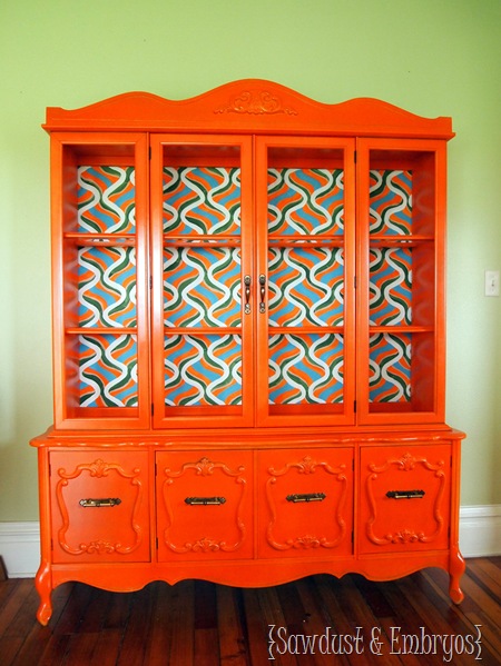 A retro orange china cabinet with hand-painted backboard is an excellent example of a DIY we sold.