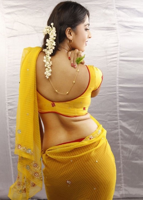 Anushka Yellow Saree Pics showing Back with Romantic Pose
