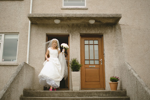 Alis chose a dupioni silk gown by Paloma Blanca. She added straps to the design.