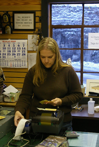 Beth Brown rings up a fishing tag.