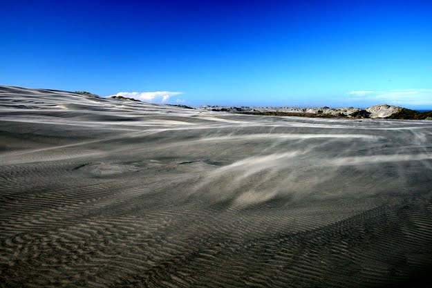 Sand blowing over dunes