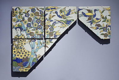 Section of a Tile Panel | Origin: Iran, Isfahan | Period: 17th century | Collection: Gift of the Ancient Art Council, Footsteps of Genghis Khan Trip, 2003, with additional funds provided by Stephen Lesser in memory of Regina K. Fadiman, and by Eugene and Carol Epstein, and Karen Schmidt (M.2004.34a-e) | Type: Ceramic; Architectural element, Fritware, cuerda seca, a-b) Courtier tile overall: 18 3/8 x 9 1/4 x 15/16 in. (46.67 x 23.5 x 2.38 cm) each; c) Duck flying tile (right): 9 1/8 x 9 1/8 x 1 3/8 in. (23.18 x 23.18 x 3.49 cm); d) Triangular floral tile: 3 x 3 1/4 x 1 in. (7.62 x 8.26 x 2.54 cm); e) Flying duck tile (left): 9 3/8 x 9 1/4 x 3/4 in. (23.81 x 23.5 x 1.91 cm)