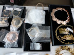 A few trays of jewelry and accessories including a Jennifer Behr haircomb and Jennifer Fisher bracelets (on the left).