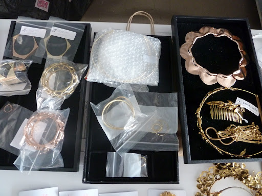 A few trays of jewelry and accessories including a Jennifer Behr haircomb and Jennifer Fisher bracelets (on the left).