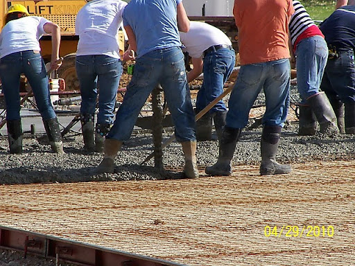 Members of the Aurora Jehova's Witness laying the concrete foundation. (Photo by Art Morris)