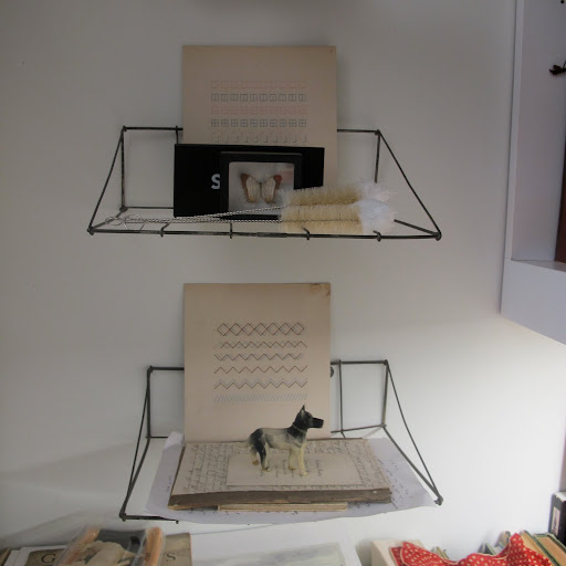 Vintage wire shelves display some of Fritz's favorite objects, including figurines and sewing patterns. Vintage wire shelves display some of Fritz's favorite objects, including figurines and sewing patterns.