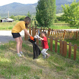 Run Wild Missoula Director Eva Dunn-Froebig and her son, Milo, clean up the Missoula Marathon course.