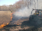 Polaris Ranger crew moving up to extinguish line between pond and the woods