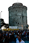Marching from the White Tower, the yellow flags are from a movement of non-compliance with road tolls. Privatization sold off the roads of Greece to private companies. One way Greeks have fought the austerity is by refusing to pay new social fees.