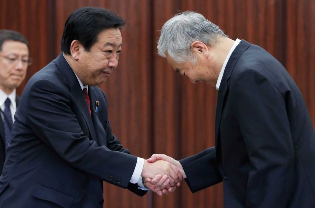 Japanese Prime Minister Yoshihiko Noda, left, shakes hands with Yotaro Hatamura, chairperson of the Investigation Committee on the Accident at the Fukushima Dai-ichi Nuclear Power Station of Tokyo Electric Power Co. after receiving the final report by the committee on the accident from Hatamura following the committee meeting in Tokyo Monday, 23 July 2012. Shizuo Kambayashi / AP