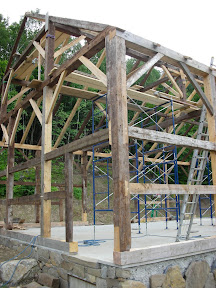 In the foreground is the post with the strange foot repair shown earlier.  This post also required repairs to four shoulders.  The long inlayed dovetail repair on the eave wall also features secondary dovetailing hidden inside.