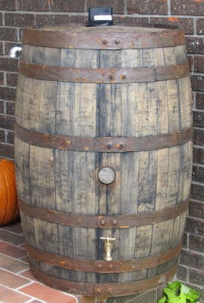 This recycled White Oak whiskey barrel is outfitted with a spout and overflow pipe.