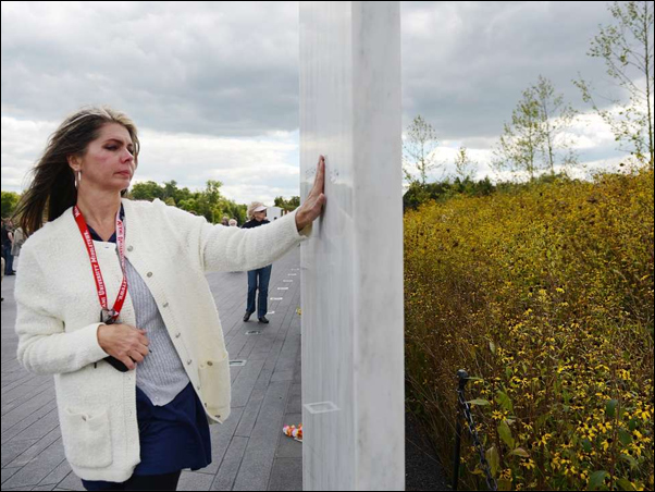 Melissa Taylor, of Cincinnati, visits the Flight 93 memorial near Shanksville. Scientists are blaming insect swarms that weren't there 20 years ago on climate change. Photo: AP