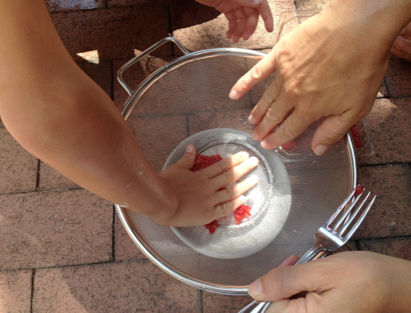 We separated the berries and mashed them up with a fork—and then eventually our fingers—in a strainer. Then we added ¼ cup of water into each bowl to create the “paint.”