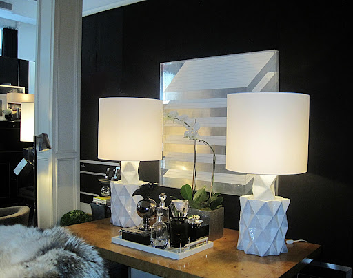 I felt transported back to the days of Studio 54. The graphic quality of the pair of lamps and the drum shades look great against the dark wall and the art hanging on it.