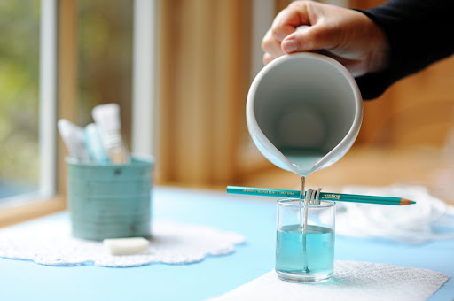 Step 7: Pour the colored wax into the candleholder slowly.
