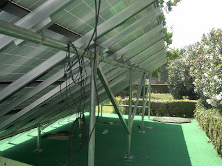 A picture showing underside of the back rack after panel assemblies were attached. Next comes the task of connecting and routing the panel cables. This was our first UniRac ground mount system. Now what we like to do is to attach either 1 or 1 1/4" pvc to under side using "mini's". We then route the cabling through the conduit to the inverter or inverters. We have photos of this being done in one of our installs.