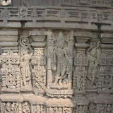 Here again we see an animal with long ears, sitting at the base of central niche. Could it be jackal? The person could be indetified if the animal identification can be fixed.
