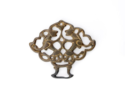 Ornament with a pair of lions | Origin:  Turkey | Period: 13th century?  Saljuq period | Details:  Not Available | Type: Bronze, traces of gilding | Size: H: 5.4  W: 6.2  cm | Museum Code: F1978.48 | Photograph and description taken from Freer and the Sackler (Smithsonian) Museums.