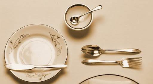 On the left is the bread plate and butter knife. At the top is the saltcellar, which can be set anywhere above the dessert utensils. And on the right is the dessert spoon and fork (the spoon is set above the fork in the opposite direction of the fork).