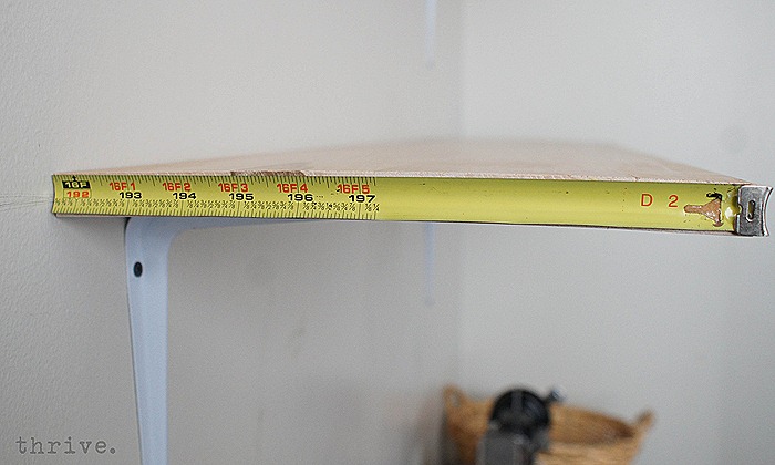 Use a busted tape measure to decorate shelves - choosetothrive.blogspot.com
