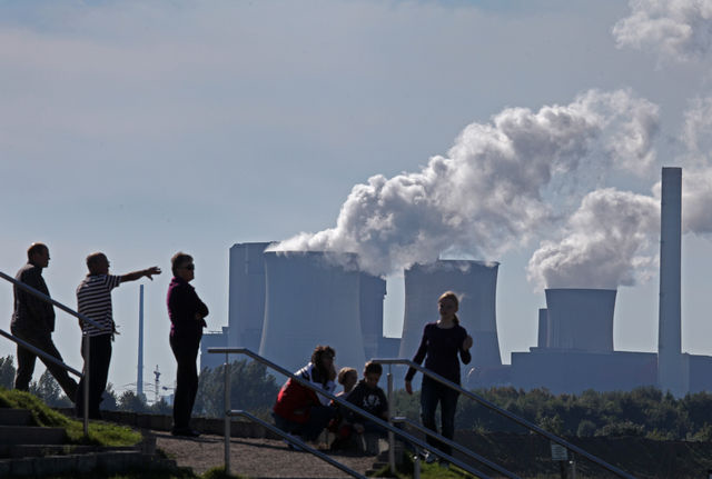 Visitors stand on the observation tower in front of the RWE AG coal-fueled power plant in Weisweiler, Germany. Hannelore Foerster / Bloomberg