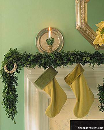 Different shades of green work together on this mantle from the stockings to the greenery to the bobeches in the candlesticks.