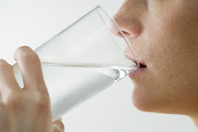 Woman Drinking Glass of Water --- Image by © Royalty-Free/Corbis