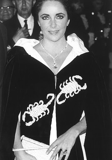 This cape was what Elizabeth wore to Grace Kelly's Scorpion themed birthday in Monte Carlo. (photo, Elizabeth Taylor:My Love Affair With Jewelry) This cape was what Elizabeth wore to Grace Kelly's Scorpion themed birthday in Monte Carlo. (photo, Elizabeth Taylor:My Love Affair With Jewelry)