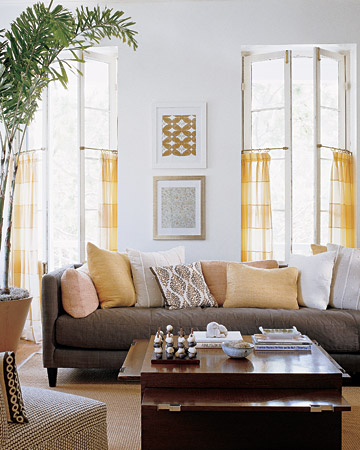 The use of brown and yellow against a crisp gray wall is calming in this sunny room. The use of brown and yellow against a crisp gray wall is calming in this sunny room.