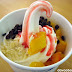 California Berry frozen yogurt with mango, crushed almonds and choco chips and drizzled with strawberry syrup
