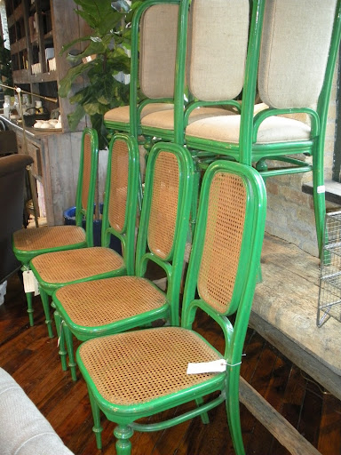Vintage green chairs, with caning or upholstery.