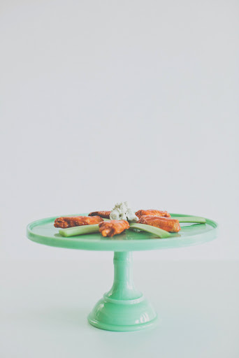 Buffalo wings get a fancy presentation: on a lovely cake stand. These were prepared with Jidori chicken, Point Reyes bleu cheese dipping sauce, and celery sticks.