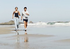 young couple running on the beach