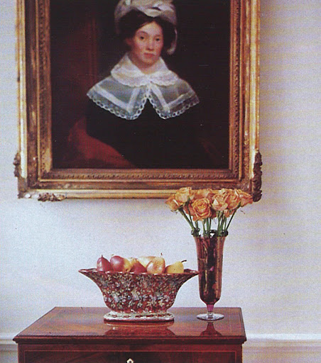 A wooden side table sits beneath an unsigned portrait that has been attributed to the artist Samuel F.B. Morse, who was also the inventor of the Morse code.