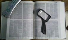 c0 Compact Oxford English Dictionary Open with magnifying glass; TV remote shown for scale