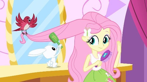 A human Fluttershy brushes her hair in front of a vanity while a bird holds up a length and her rabbit, Angel, helps brush