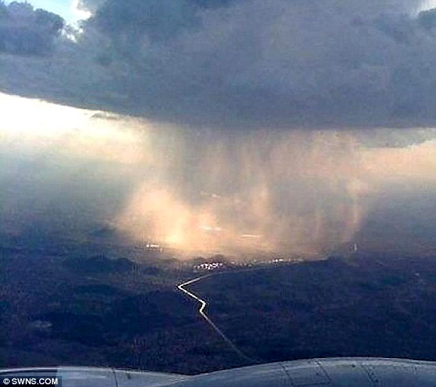 In the thick of it: A giant rain cloud, seen from a light aircraft, pours its contents down on Burbage between Leicester and Birmingham, 29 June 2012. SWNS.com via dailymail.co.uk