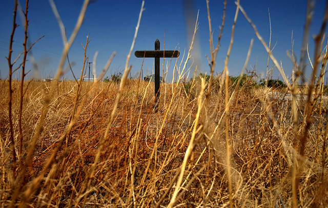 Verhalen, Texas — Dry weeds surround a wooden cross in a field near the town of Verhalen, in May 2011. The state is suffering from a severe drought that is causing wildfires and hardship for ranchers and farmers. Genaro Molina / Los Angeles Times