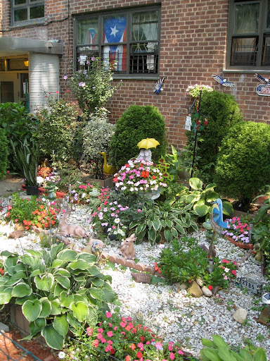 This garden near the building's entrance is kept neat as a pin. This garden near the building's entrance is kept neat as a pin.