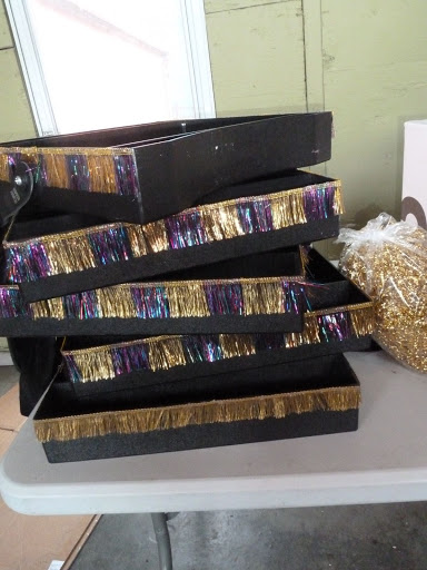 Black trays were trimmed with metallic fringe, and used to pass out late-night props, cigarette-girl style.