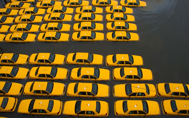 A parking lot full of yellow cabs is flooded as a result of Hurricane Sandy in Hoboken, New Jersey. Photo: Charles Sykes / AP
