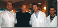 Actor Woody Harrelson with some of the barbers at the Terminal Barbershop in Toronto, Canada