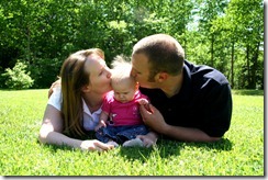 Young Family kissing baby