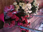 The runway was bordered by plastic and tin buckets filled with flowers. It gave the space the feel of a garden.
