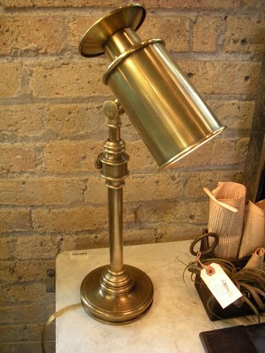 This brass spot light lamp adds a nice accent to a room.